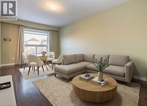Kitchener townhouse for rent - A living room with a couch, chairs, and a coffee table.