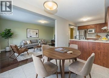 Kitchener townhouse for rent - A living room with a dining table and chairs.