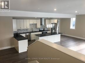Ottawa multi-family for rent - A modern kitchen with a large island and stainless steel appliances.
