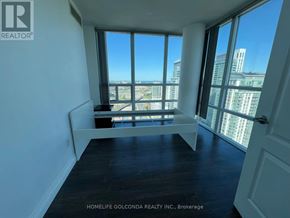 Toronto (Bendale) condo for rent - A room with a large window overlooking a cityscape.