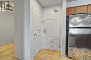 Richmond Hill (Langstaff) condo for rent - A kitchen with a white door and a white fridge.