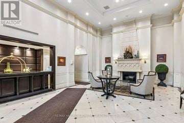 Richmond Hill (Langstaff) condo for rent - A well-lit, elegant living room with a fireplace and a dining table set up.