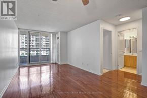 Richmond Hill (Langstaff) condo for rent - A large empty room with a wooden floor and a sliding glass door.