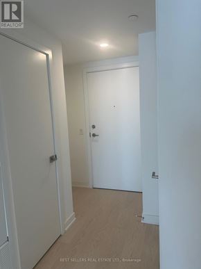 Toronto (Church-Yonge Corridor) condo for rent - A hallway with white walls and a wooden floor.