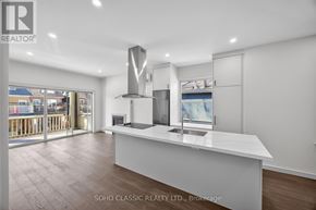 Toronto (The Beaches) apartment for rent - A modern kitchen with a large island and stainless steel appliances.