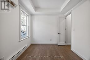Toronto (The Beaches) apartment for rent - A white room with a door and a window.