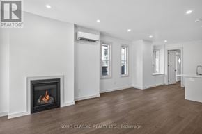 Toronto (The Beaches) duplex for rent - A living room with a fireplace and wood flooring.
