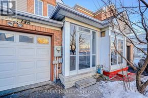 Markham (Cedarwood) townhouse for rent - A house with a white garage door and a red brick wall.
