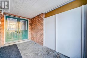 Markham (Cedarwood) townhouse for rent - A white door is on the right side of a brick wall.