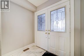 Markham (Cedarwood) townhouse for rent - A white door with a glass window and a handle.