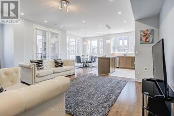 Oakville (Jm Joshua Meadows) townhouse for rent - A modern living room with a white sofa and a grey rug.