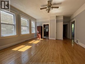 Windsor apartment for rent - A room with wooden floors and a ceiling fan.