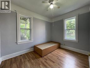 Windsor apartment for rent - A room with a bed in the middle and a fan on the ceiling.