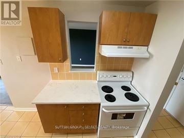 London South (South M) condo for rent - A kitchen with a stove and cabinets.