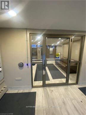 London South (South M) condo for rent - A modern entrance with a glass door and a black mat on the floor.