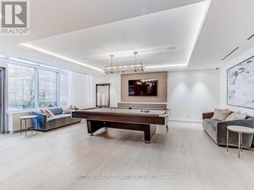 Toronto (Annex) condo for rent - A spacious living room with a pool table and a couch.