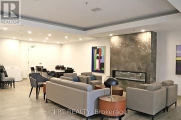 Toronto (Yonge-St. Clair) condo for rent - A living room with a grey couch and a fireplace.
