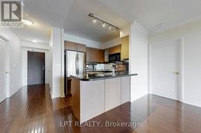 Toronto (Yonge-St. Clair) condo for rent - A spacious kitchen with wooden floors and modern appliances.