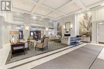 Oakville (Co Central) condo for rent - A well-lit, spacious living room with a large rug and a variety of seating options.