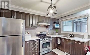 Toronto (Humber Summit) apartment for rent - A kitchen with a stainless steel refrigerator and wooden cabinets.