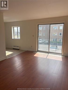Windsor apartment for rent - A room with a window and sliding glass doors.