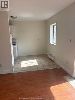 Windsor apartment for rent - A room with a large window and wooden flooring.