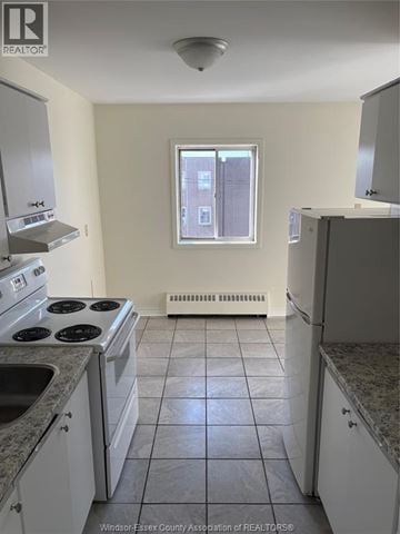 Windsor apartment for rent - A kitchen with white cabinets and a black stove top.