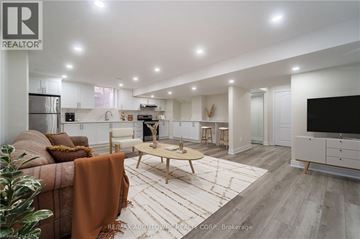 Milton apartment for rent - A modern living room with a brown sofa and a wooden coffee table.