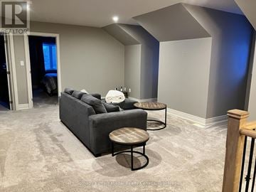 Blue Mountains apartment for rent - A living room with a grey couch and a round table.