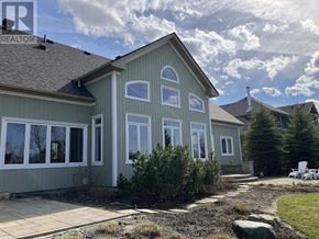 Blue Mountains apartment for rent - A house with a grey roof and white windows is surrounded by a garden.