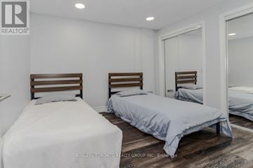 Toronto (Lansing-Westgate) apartment for rent - A bedroom with two beds and a mirror on the wall.