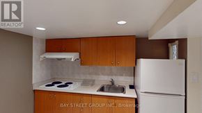 Markham (Grandview) apartment for rent - A kitchen with a white refrigerator and brown cabinets.