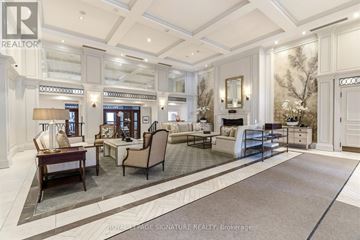 Oakville (Co Central) condo for rent - A well-lit, spacious living room with a large rug and a variety of seating options.