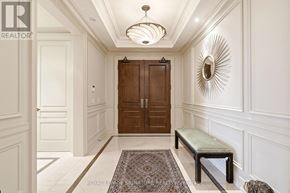 Oakville (Co Central) condo for rent - A hallway with a bench and a door.