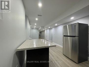 Brampton (Northwest Brampton) apartment for rent - A kitchen with a stainless steel refrigerator and a granite countertop.