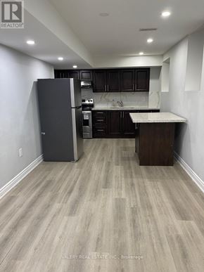 Brampton (Northwest Brampton) apartment for rent - A kitchen with a refrigerator, cabinets, and a countertop.