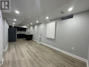 Brampton (Northwest Brampton) apartment for rent - A room with wood flooring and white walls, with a logo for REALTOR on the top left.