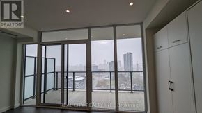 Kitchener condo for rent - A room with a view of the city through large windows.