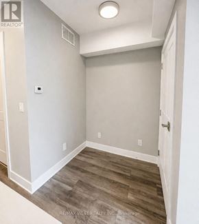 Niagara Falls (Arad/Fallsview) townhouse for rent - A room with a wooden floor and white walls.