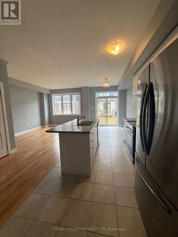 Welland (Dain City) townhouse for rent - A kitchen with a refrigerator on the right side.