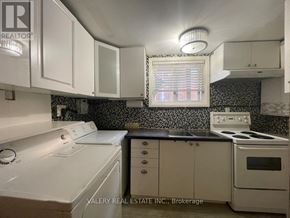 Hamilton (Balfour) apartment for rent - A kitchen with white appliances and black and white tiles.