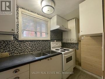 Hamilton (Balfour) apartment for rent - A kitchen with a stove top oven and a sink.