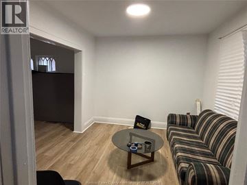 Windsor apartment for rent - A living room with a striped couch and a coffee table.