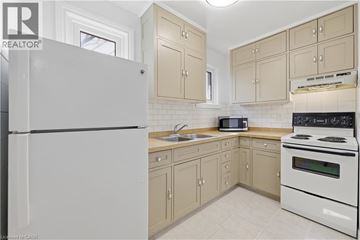 Hamilton apartment for rent - A kitchen with a white refrigerator and a white stove.