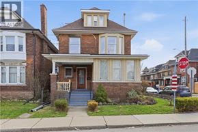 Hamilton apartment for rent - A house with a brown brick exterior and a white trim.