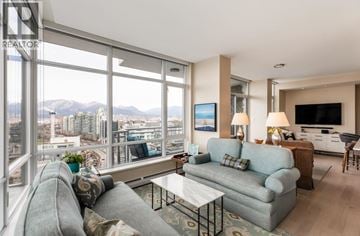 Vancouver apartment for rent - A living room with a grey couch and a coffee table.