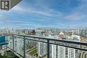 Vancouver apartment for rent - A balcony overlooks a cityscape with a mix of residential and commercial buildings.