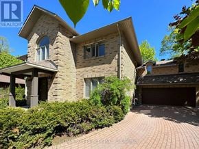 Ottawa apartment for rent - A house with a garage and a driveway in front of it.