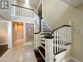 Ottawa apartment for rent - A staircase with a black handrail and white balusters leads to a second floor.