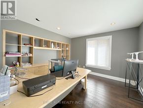 Ottawa apartment for rent - A realtor's office with a desk, computer, and printer.